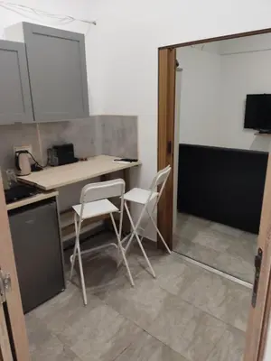 a kitchen with a desk and two white chairs at The nest in Dušanovac (historical)