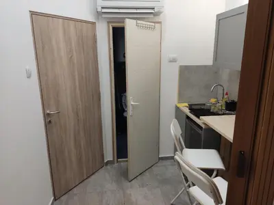 a small kitchen with a sink and a door at The nest in Dušanovac (historical)