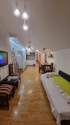 a living room with a bed and a dining room at Sky Loft in Belgrade