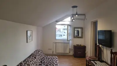 a living room with a couch and a tv at Sky Loft in Belgrade