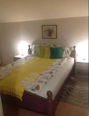 a large bed in a bedroom with two lamps at Sky Loft in Belgrade