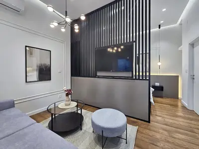 a living room with a couch and a tv at Central life in Belgrade
