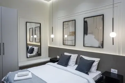 a bedroom with two beds and two mirrors at Central life in Belgrade