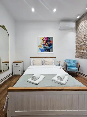 a bedroom with a large bed with two towels on it at Easy life in Belgrade