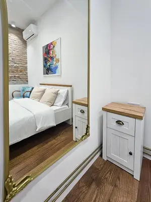 a bedroom with a bed and a mirror at Easy life in Belgrade