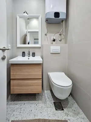 a bathroom with a toilet and a sink and a mirror at Easy life in Belgrade
