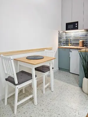 a white table and two chairs in a kitchen at Easy life in Belgrade