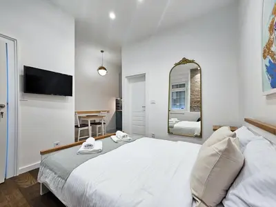 a bedroom with a large bed and a mirror at Easy life in Belgrade