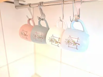 a group of four cups hanging on a rack in a kitchen at Bright & Quiet - Skadarlija in Belgrade