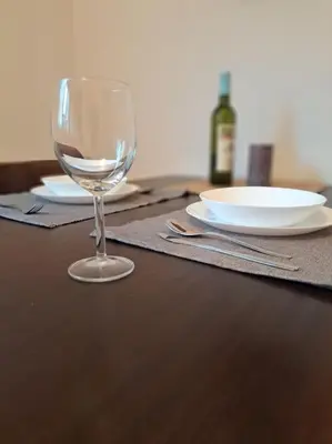 a wine glass sitting on top of a wooden table at Bright & Quiet - Skadarlija in Belgrade