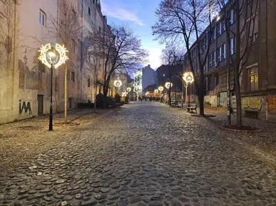 a cobblestone street with street lights and buildings at Bright & Quiet - Skadarlija in Belgrade