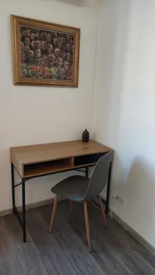 a desk with a chair and a picture on the wall at Bright & Quiet - Skadarlija in Belgrade