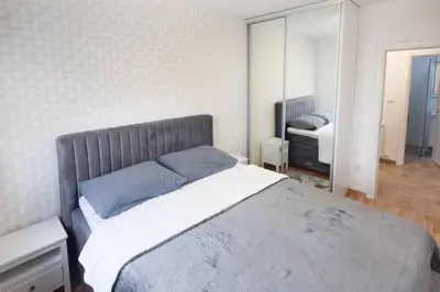 a bedroom with a large bed with blue pillows at Urban Haven in Ledine