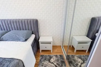 a bedroom with a bed and two night stands at Urban Haven in Ledine