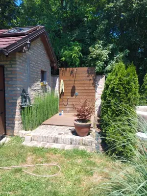a wooden deck next to a house with plants at Kuca na Savi - Stari hrast in Vladimirci