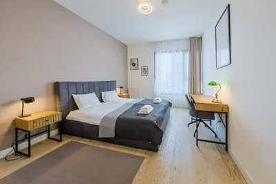 a bedroom with a bed and a desk in it at SD Luxury Apartment - Belgrade Waterfront in Belgrade