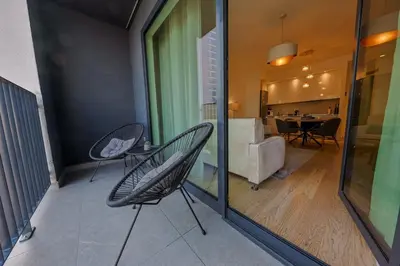 a balcony with two chairs and a couch at SD Luxury Apartment - Belgrade Waterfront in Belgrade