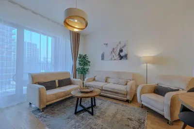 a living room with two couches and a table at SD Luxury Apartment - Belgrade Waterfront in Belgrade
