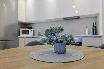 a vase sitting on top of a table in a kitchen at SD Luxury Apartment - Belgrade Waterfront in Belgrade