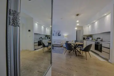 a kitchen and dining room with a table and chairs at SD Luxury Apartment - Belgrade Waterfront in Belgrade