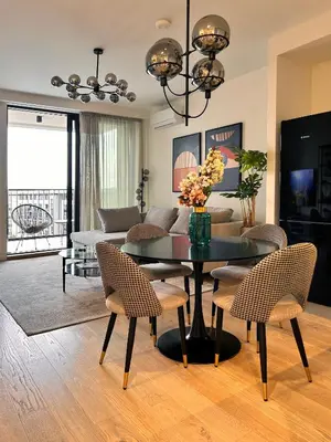 a living room with a table and chairs at SD Luxury Apartment - Belgrade Waterfront - KARE Design - River View in Belgrade