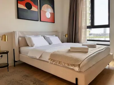a bedroom with a large bed with two towels on it at SD Luxury Apartment - Belgrade Waterfront - KARE Design - River View in Belgrade
