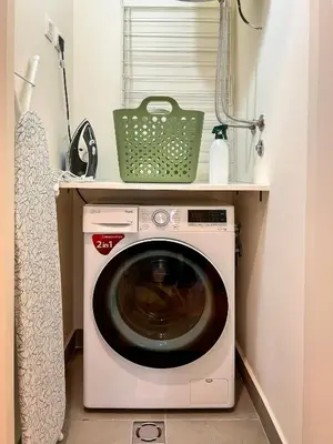 a washing machine with a green basket on top of it at SD Luxury Apartment - Belgrade Waterfront - KARE Design - River View in Belgrade