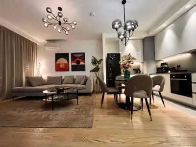 a living room with a couch and a table and chairs at SD Luxury Apartment - Belgrade Waterfront - KARE Design - River View in Belgrade