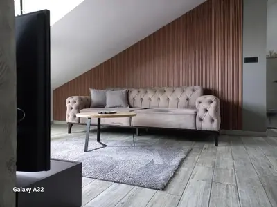 a living room with a couch and a table at New Grey in Novi Beograd