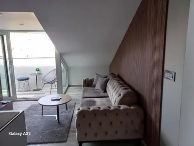 a living room with a couch and a table at New Grey in Novi Beograd