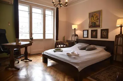a bedroom with a bed and a desk and a window at Belgrade Center Bohemian Quarter in Belgrade