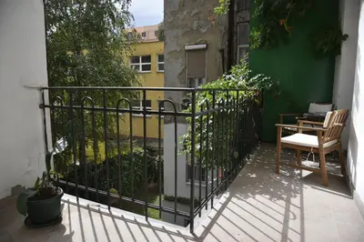 a balcony with a fence and a table and a chair at Belgrade Center Bohemian Quarter in Belgrade