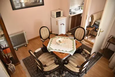 a dining room table and chairs in a living room at Belgrade Center Bohemian Quarter in Belgrade
