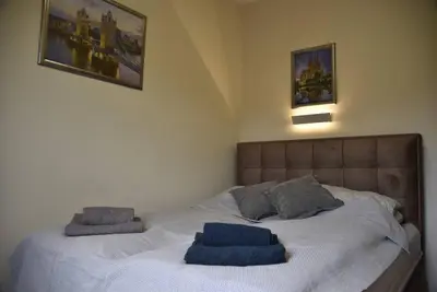 a bed with two blue towels on top of it at Belgrade Center Penthouse Duplex in Belgrade