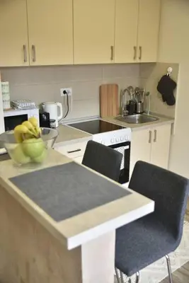 a kitchen with a bowl of bananas on a counter at Belgrade Center Penthouse Duplex in Belgrade