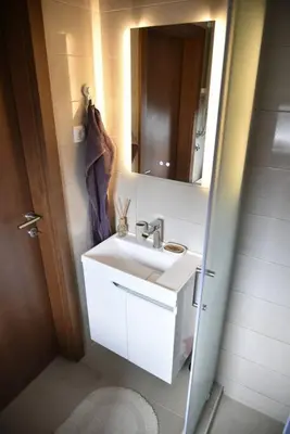 a bathroom with a sink and a mirror at Belgrade Center Penthouse Duplex in Belgrade