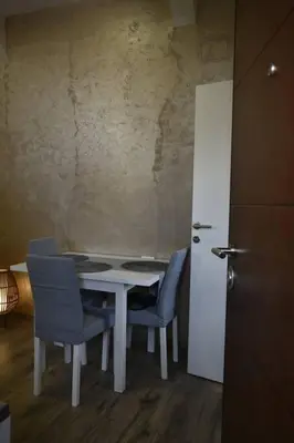 a dining room table with chairs and a white table at Belgrade Center Penthouse Duplex in Belgrade