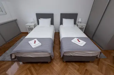 two beds in a small room with white towels at Centrum 3 in Belgrade