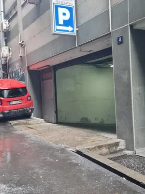 a parking garage with a red car parked in it at Centrum 3 in Belgrade