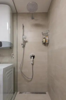 a shower with a shower head in a bathroom at Centrum 3 in Belgrade