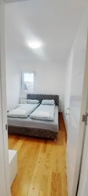 a bedroom with a bed in a white room at Magenta Zvezdara in Belgrade