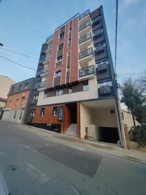 a tall building with balconies on the side of a street at Magenta Zvezdara in Belgrade