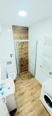 a bathroom with a shower and a toilet and a sink at Magenta Zvezdara in Belgrade