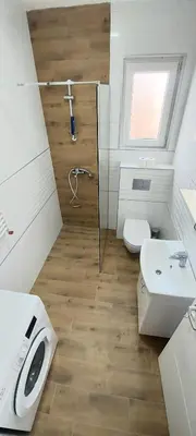 a bathroom with a shower and a toilet and a sink at Magenta Zvezdara in Belgrade