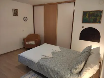 a bedroom with a bed with pillows on it at Apostolovic kuca kulturni spomenik u centru Grocke in Grocka
