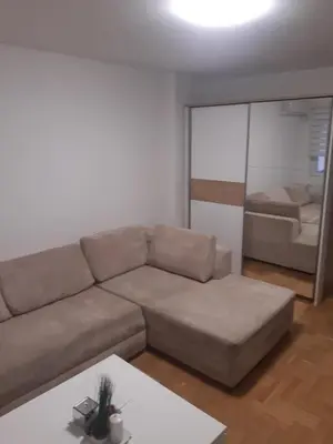 a living room with a couch and a table at Stil Apartman in Smederevo