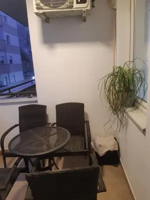 a table and chairs in a room with a table at Stil Apartman in Smederevo