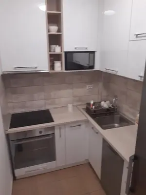 a small kitchen with a sink and a stove at Stil Apartman in Smederevo