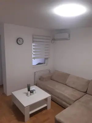 a living room with a couch and a table at Stil Apartman in Smederevo