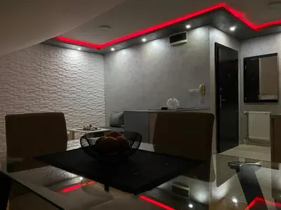 a dining room with a bowl of fruit on a table at GM Apartman Obrenovac in Obrenovac